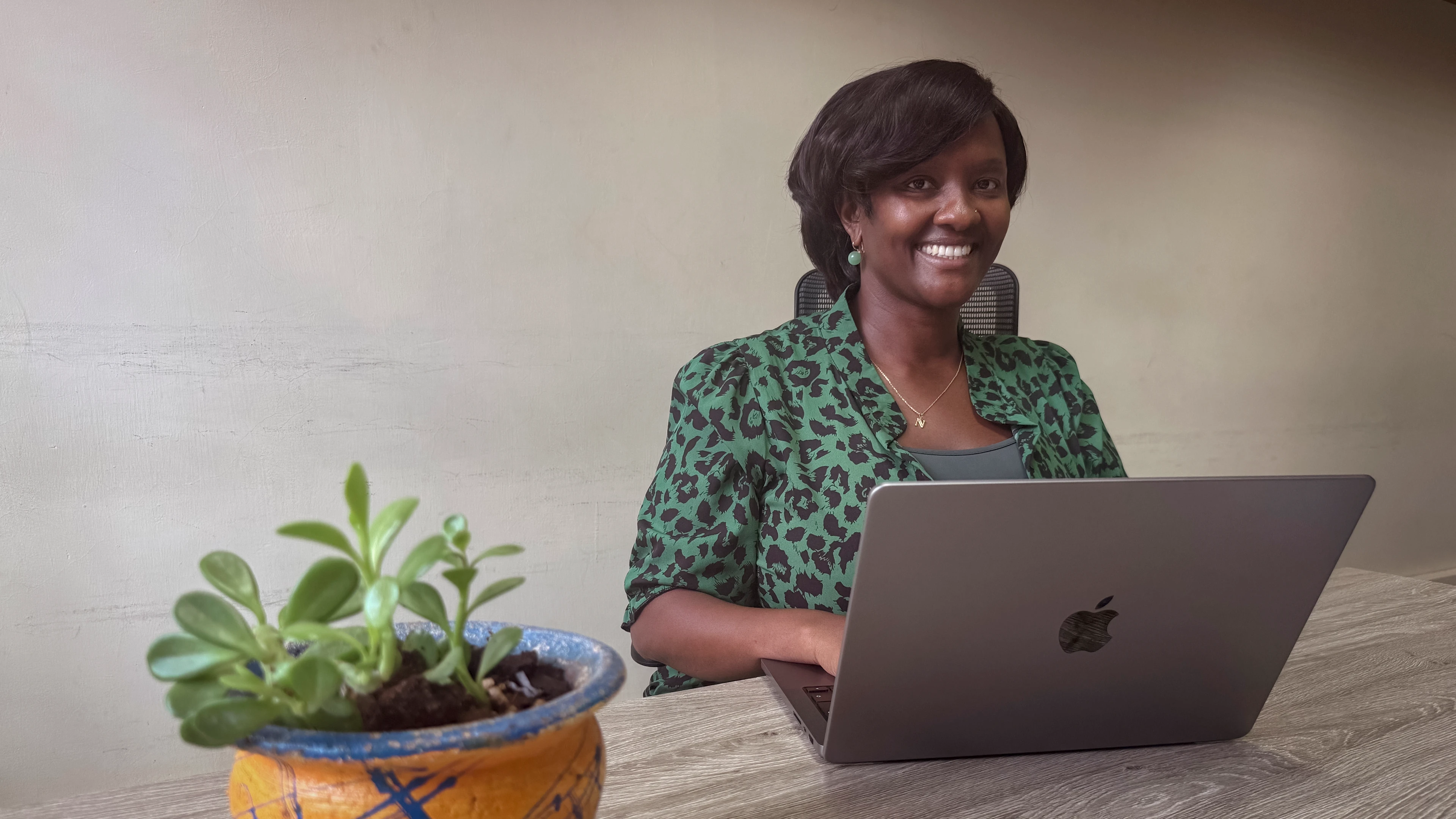 image of Dr Njoki Kimani sitting at a laptop